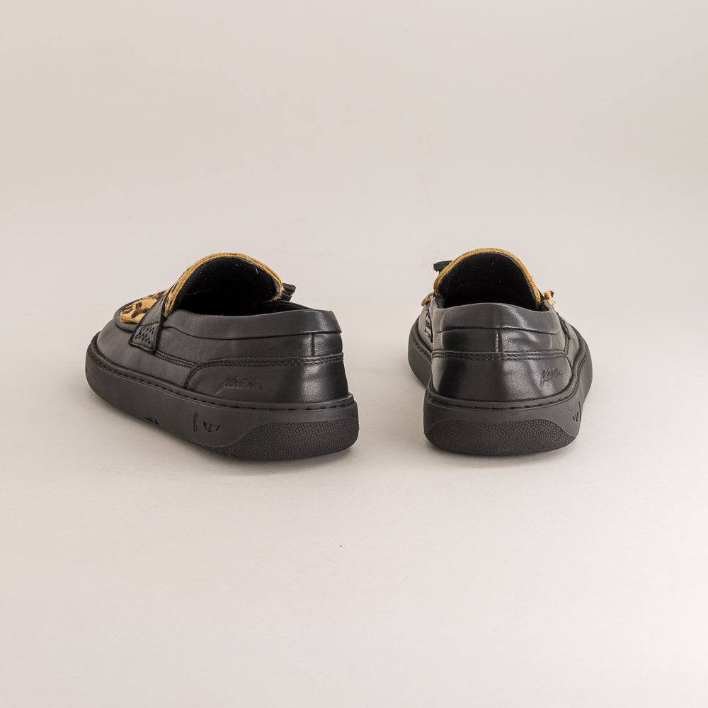 Pair of black barefoot loafers on a light gray background