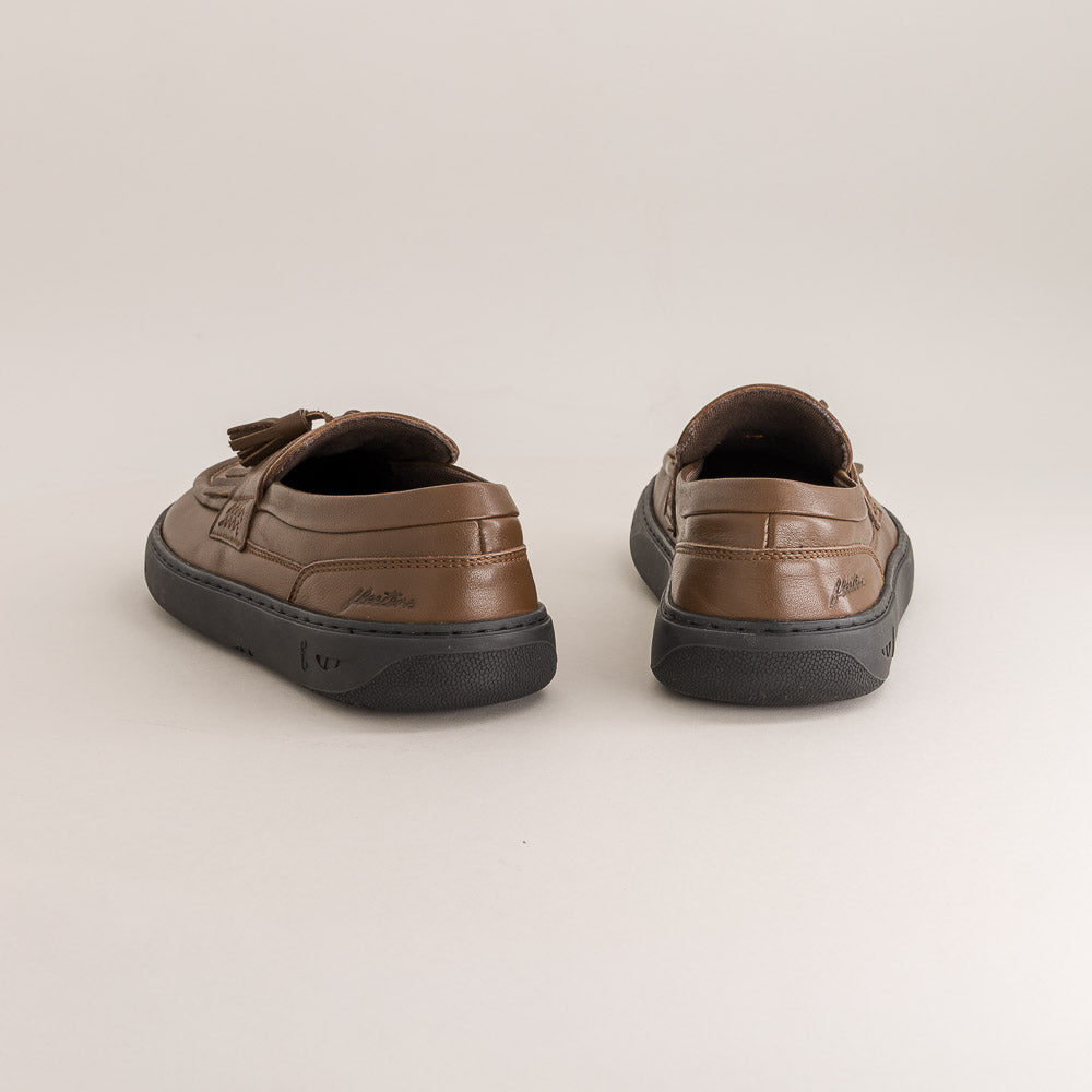 Pair of brown barefoot loafers with black soles on a light gray background
