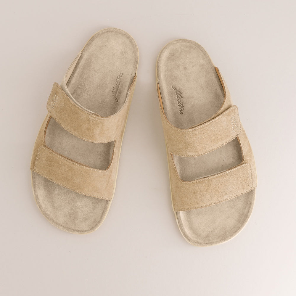 Pair of beige barefoot sandals on a light gray background