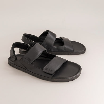 Pair of black barefoot sandals on a light gray background