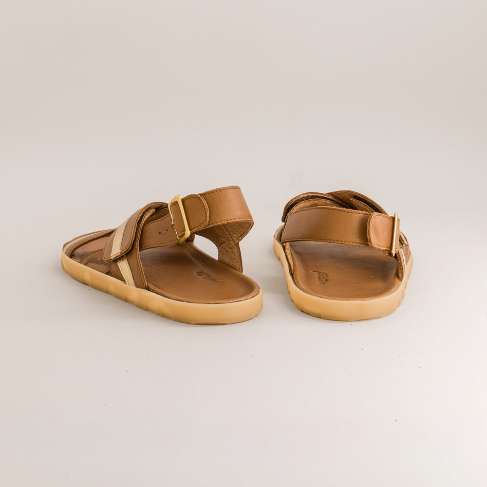 Pair of tan barefoot sandals on a light gray background