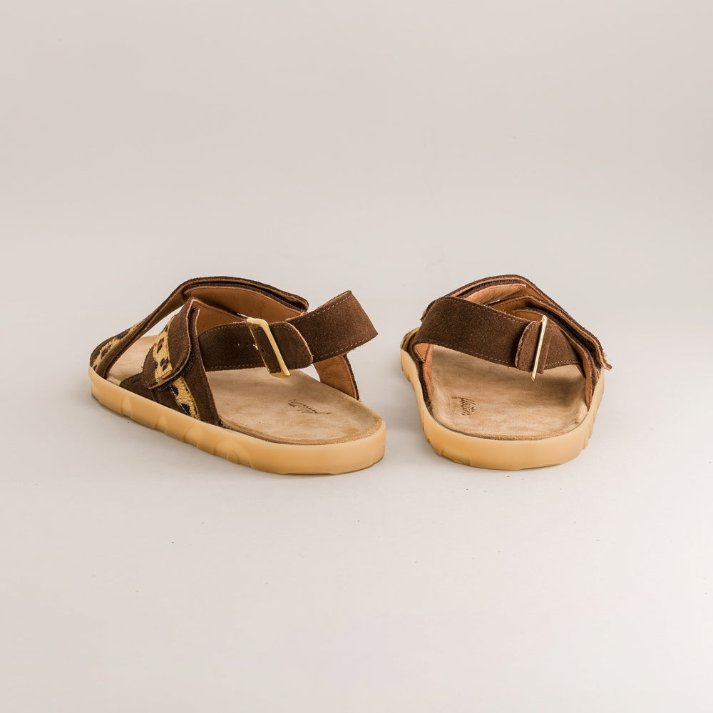 Pair of brown barefoot sandals on a light gray background
