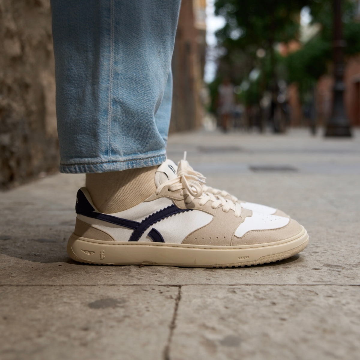person wearing blue and white barefoot sneakers 