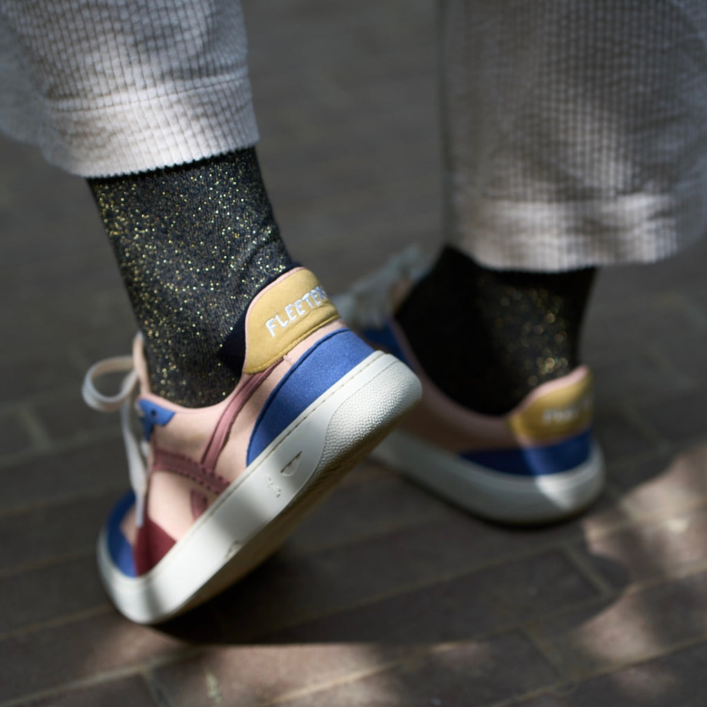 person wearing multicolored barefoot sneakers