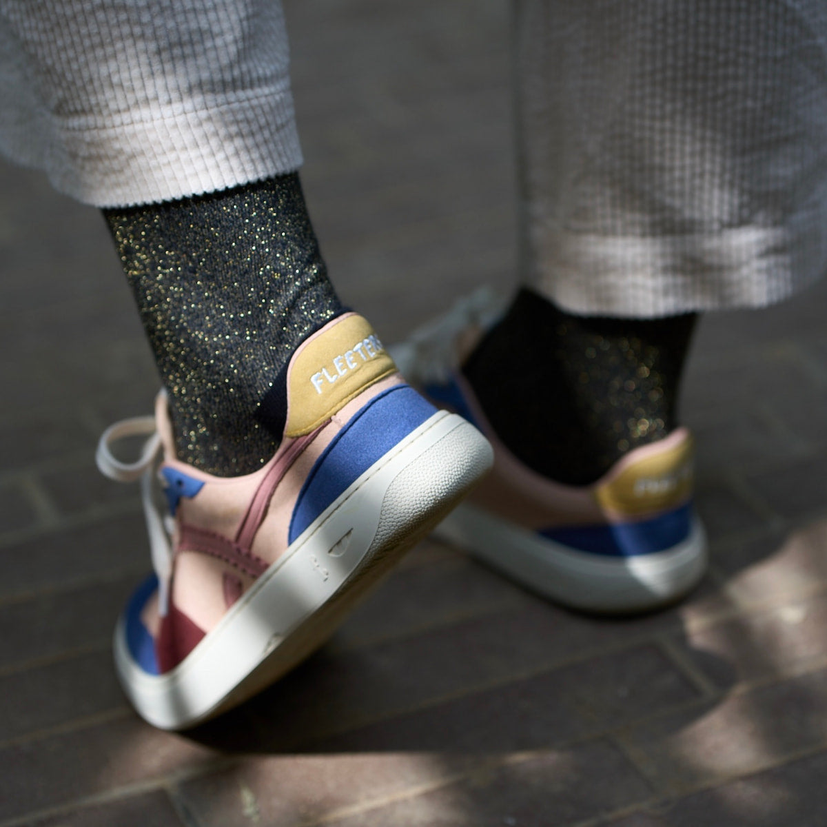 person wearing multicolored barefoot sneakers
