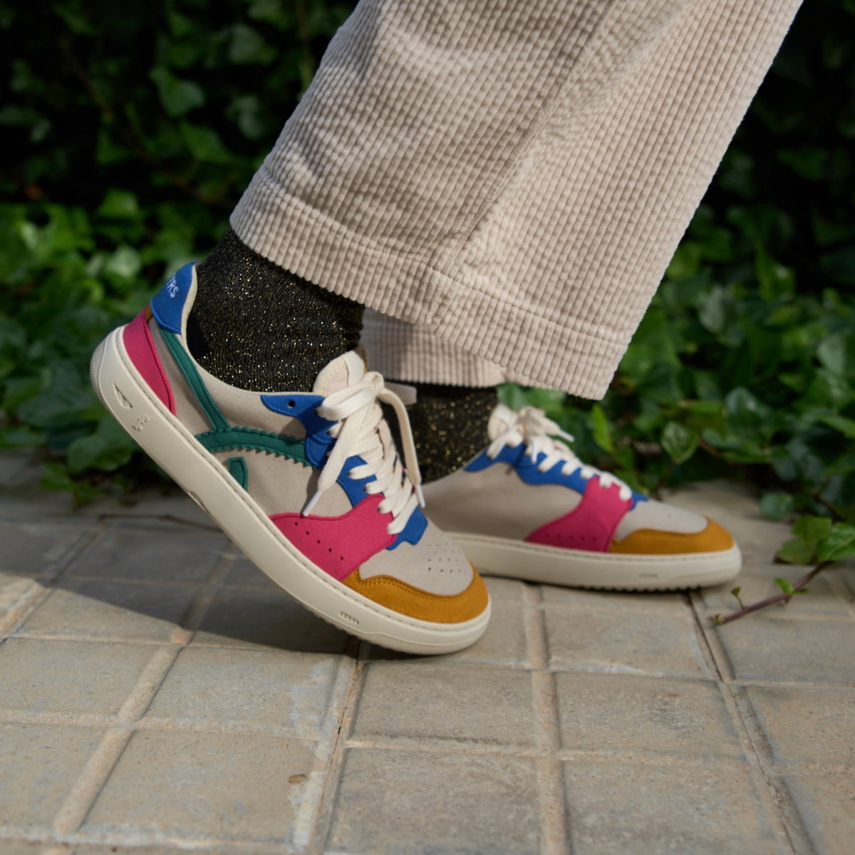 person wearing a multicolored barefoot sneaker