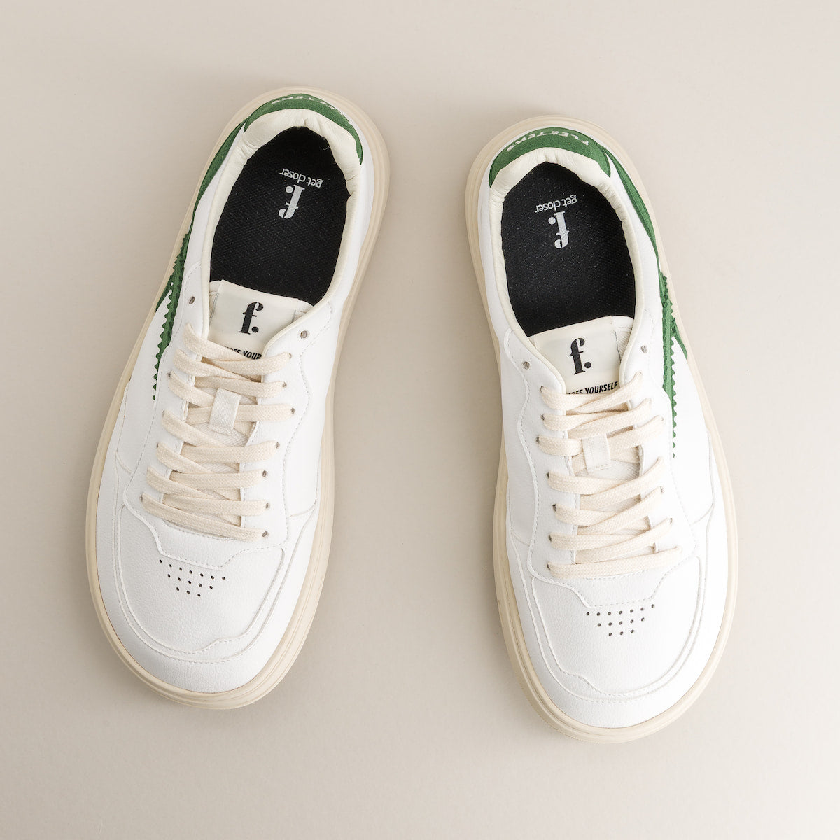 Pair of white and green barefoot sneakers 