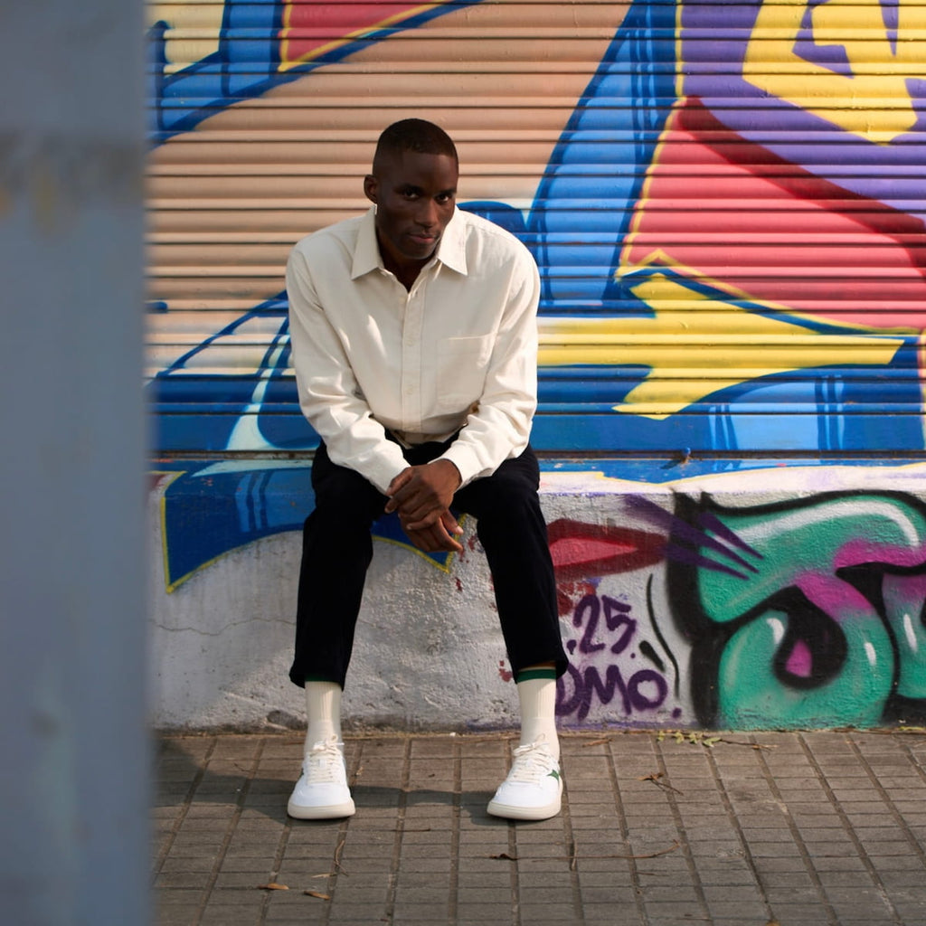 Boy wearing white and green barefoot sneakers 