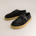 Pair of black suede barefoot derby shoes with tan soles on a light gray background