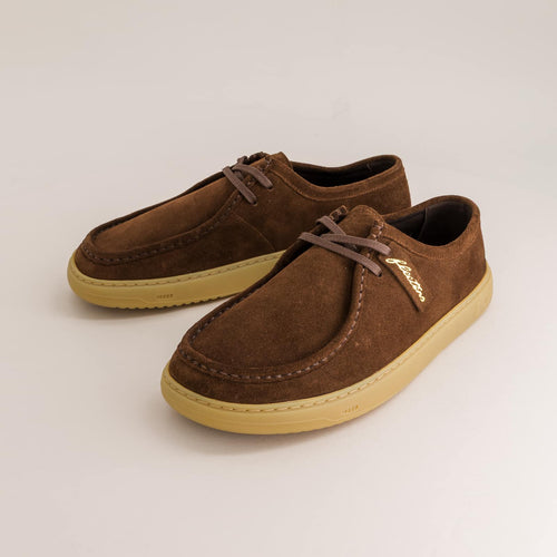 Pair of brown suede barefoot derby with tan soles on a light gray background