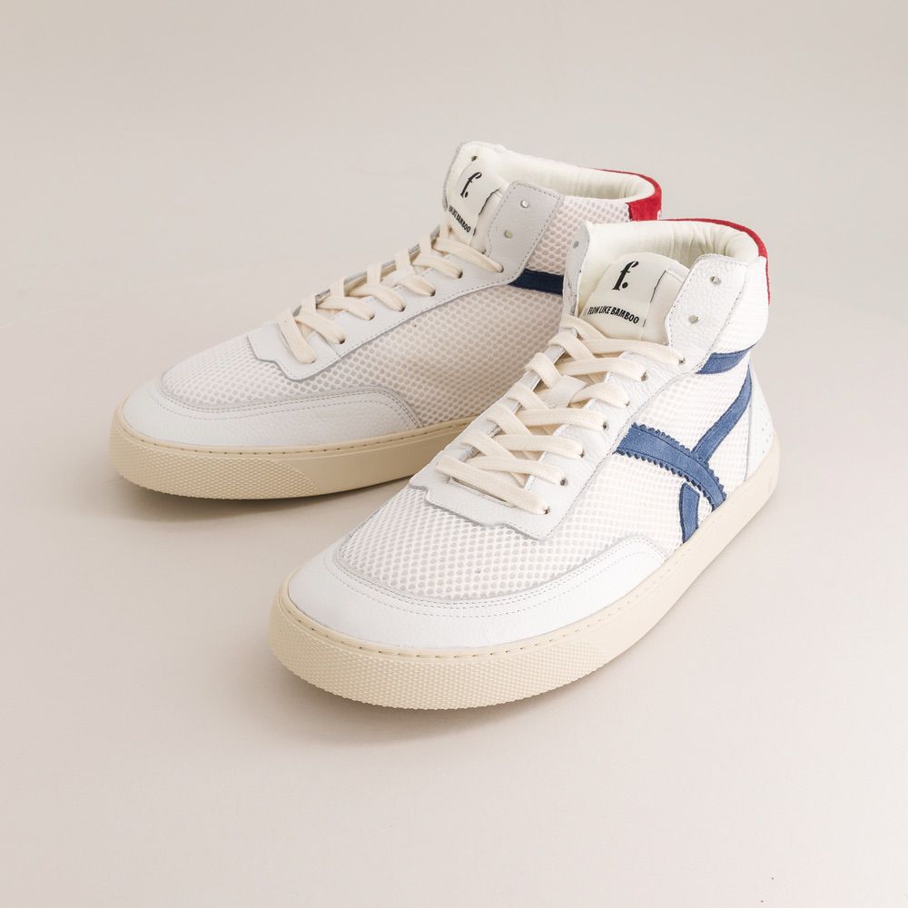 White mid-ankle barefoot sneakers with blue accents on a light gray background