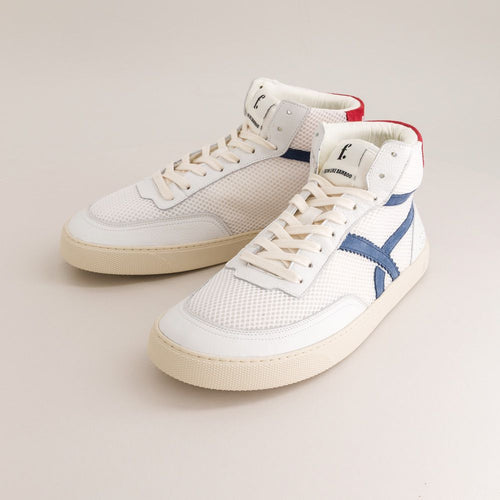 White mid-ankle barefoot sneakers with blue accents on a light gray background