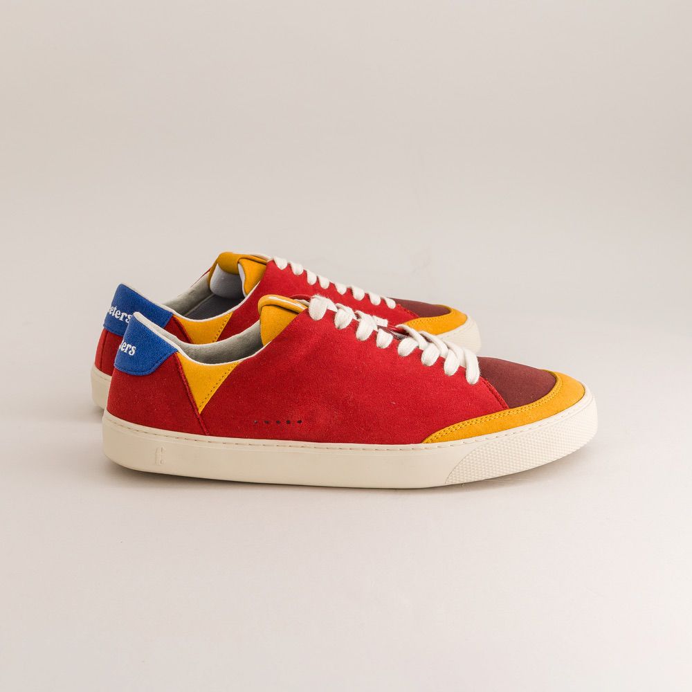 Red barefoot sneakers with colorful accents on a light gray background