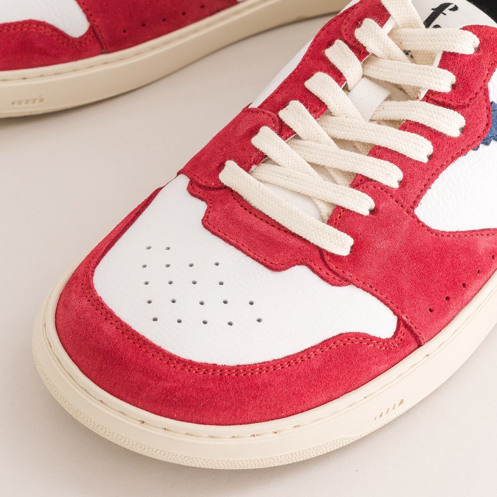 Red and white barefoot sneaker with visible brand logo on a light background