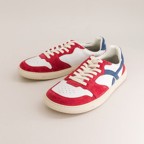Red, white, and blue barefoot sneakers on a light gray background