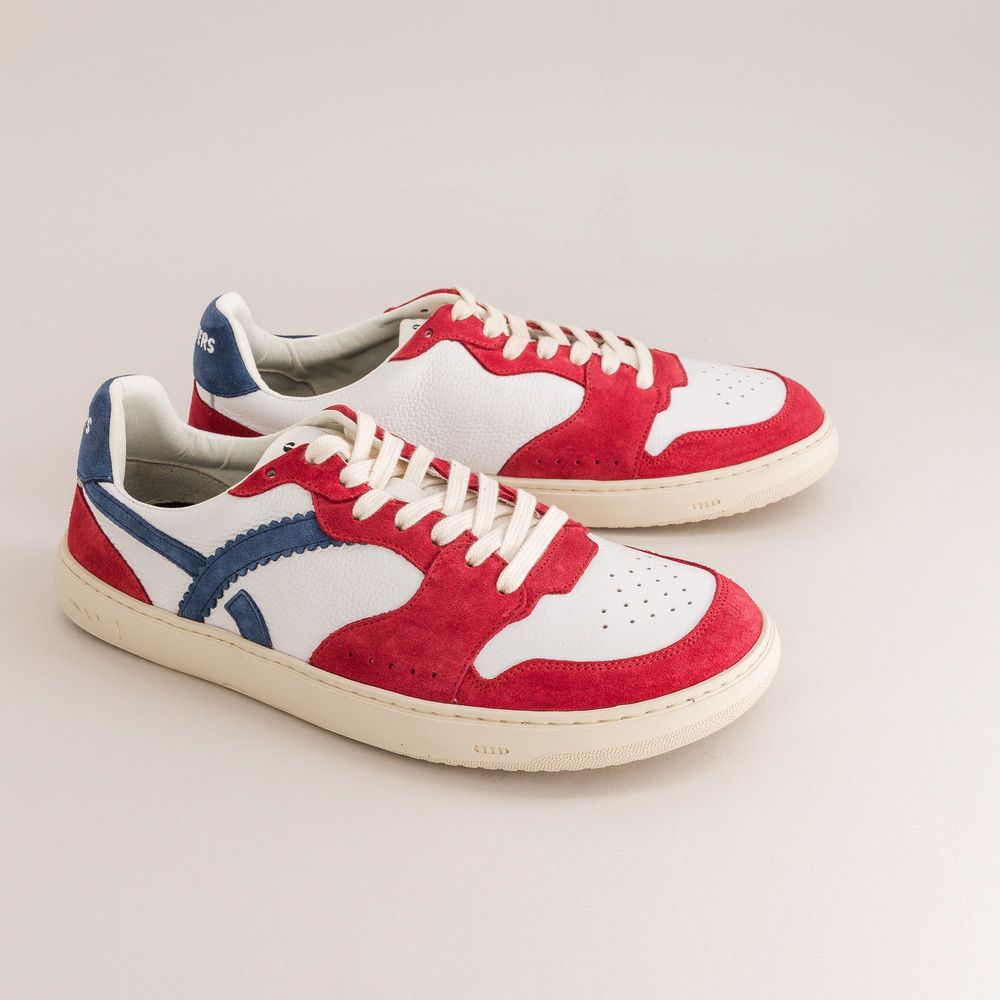 Red, white, and blue barefoot sneakers on a light gray background