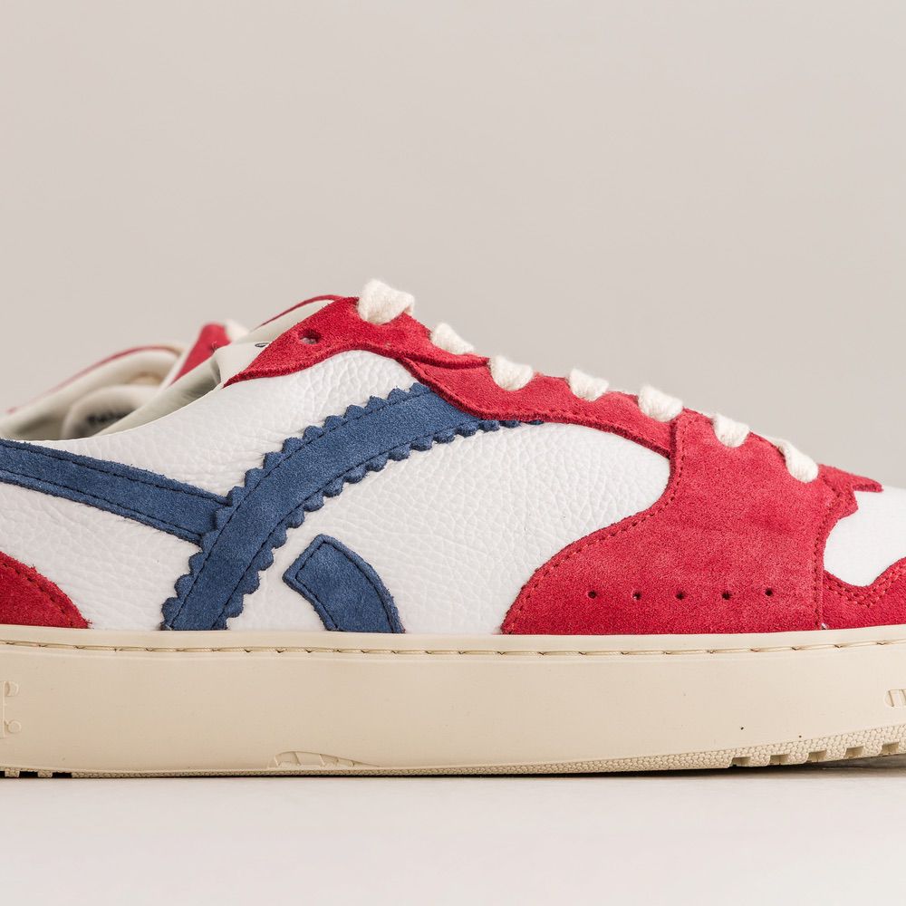 Red, white, and blue sneaker on a light gray background