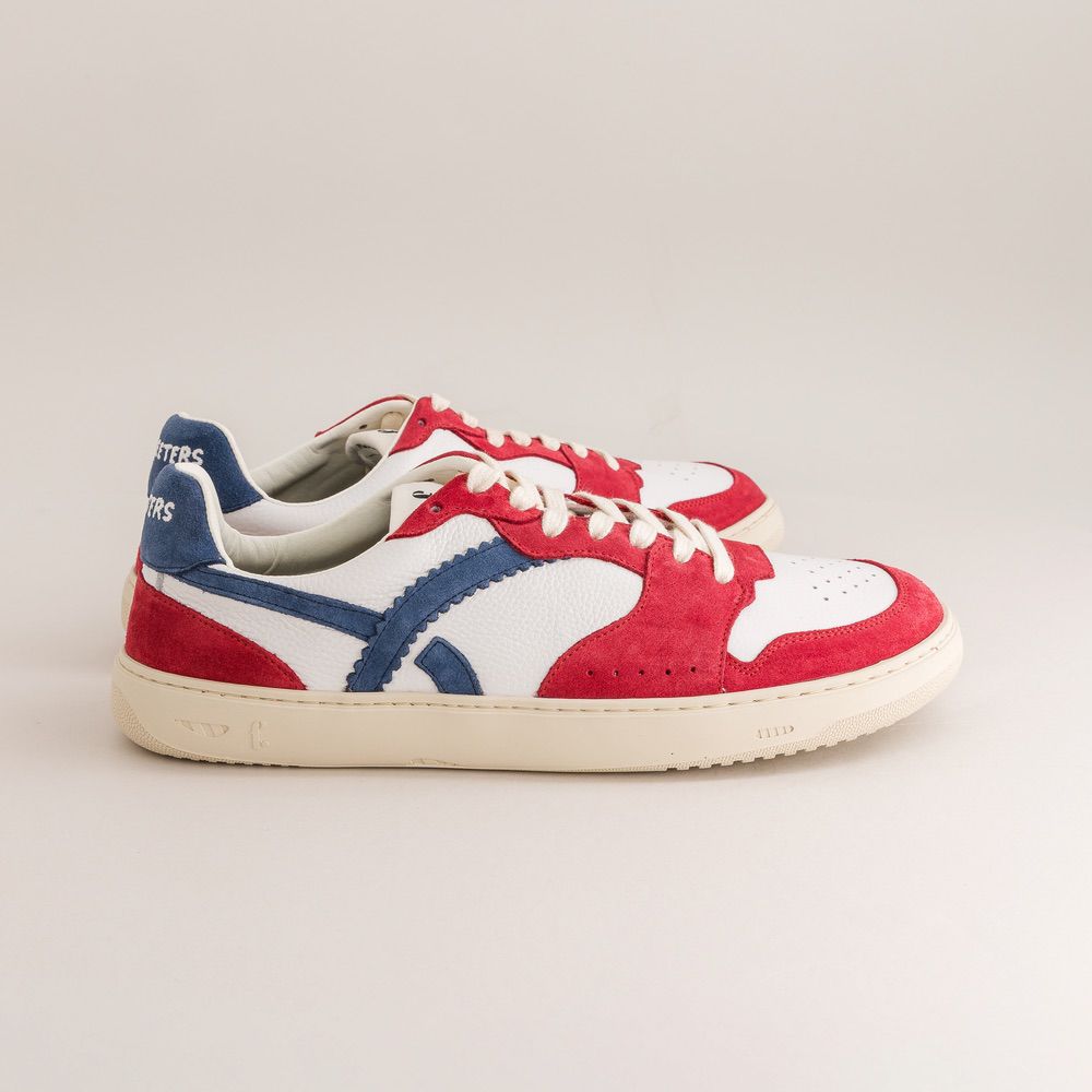 Red, white, and blue sneaker on a light gray background
