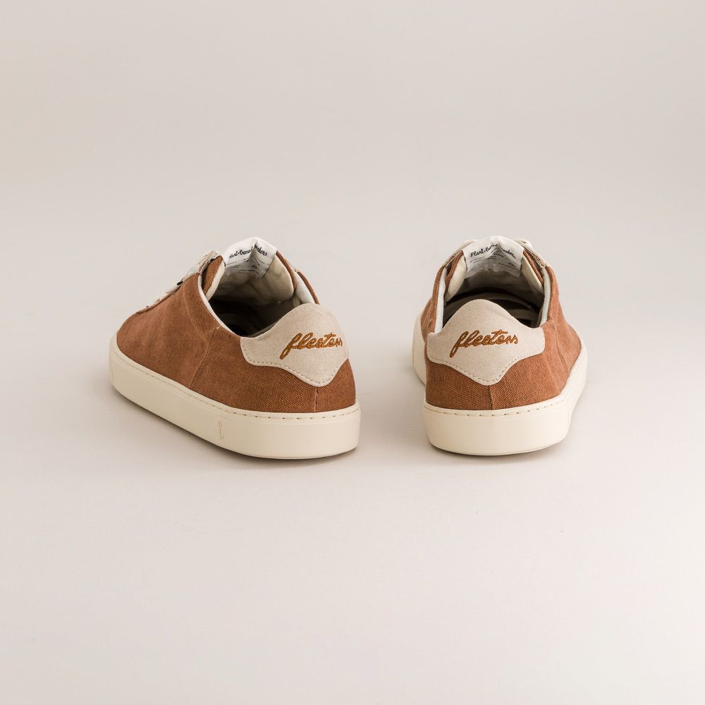 Pair of brown and white canvas minimalist sneakers with 'fleeters' branding on a light gray background