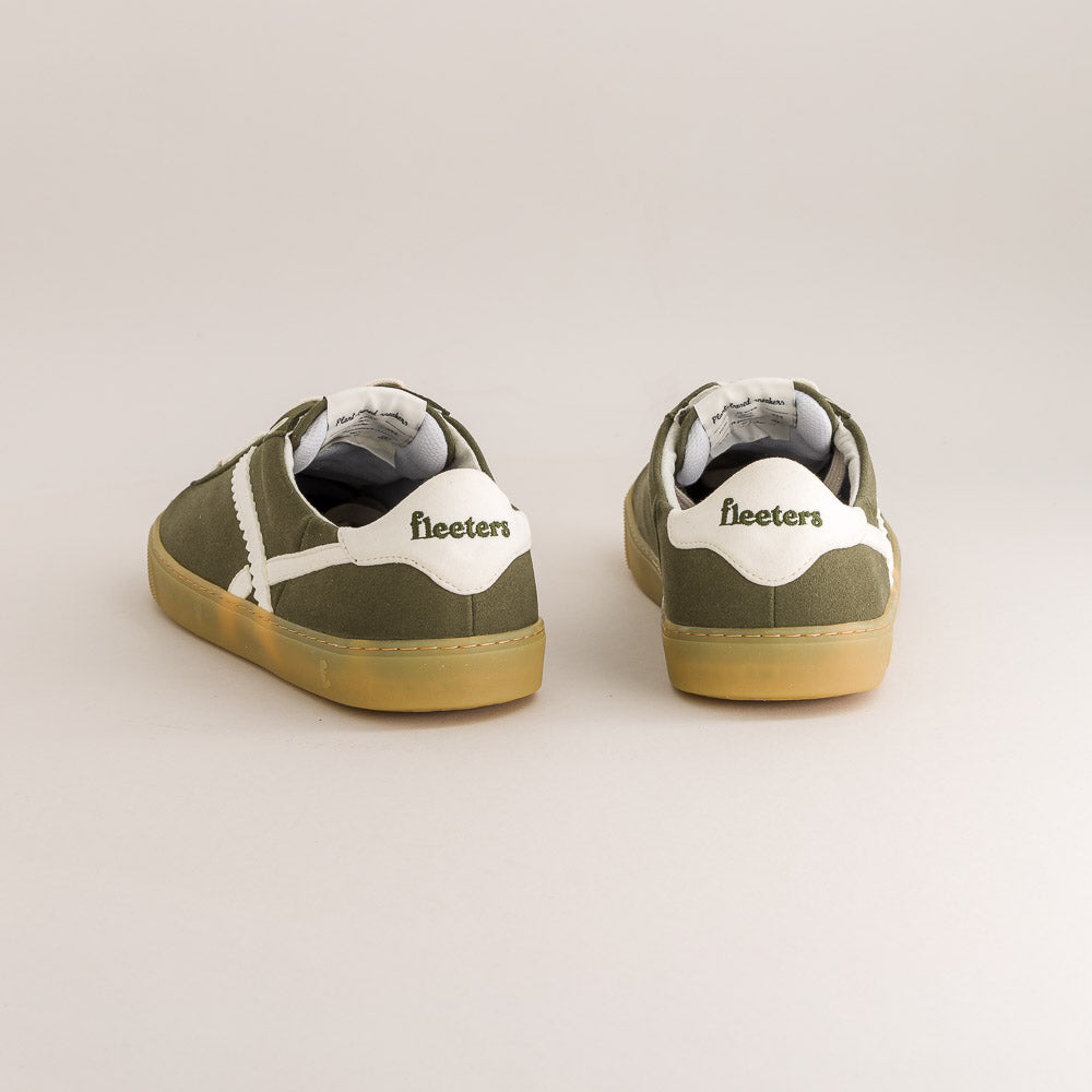 Pair of green barefoot sneakers with white soles on a light gray background