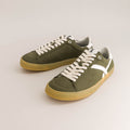 Pair of green barefoot sneakers with white laces on a light gray background