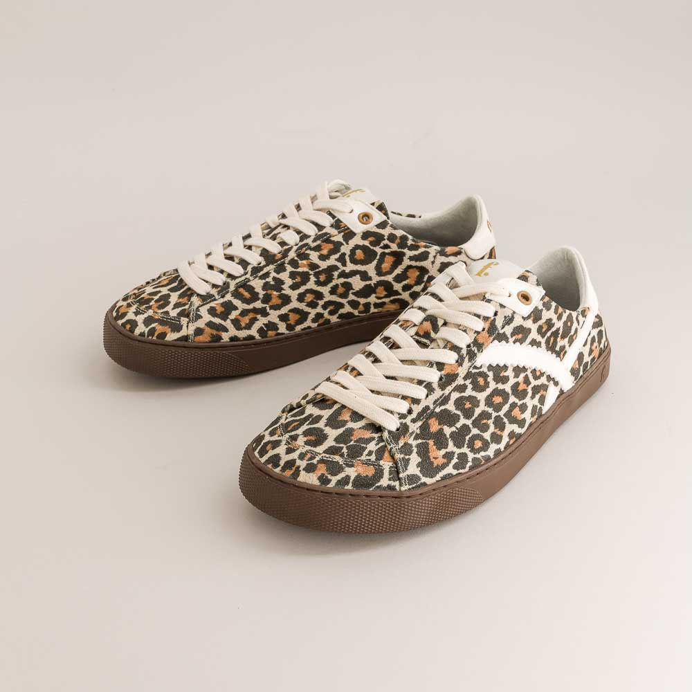 Leopard print barefoot sneakers with brown soles on a light gray background