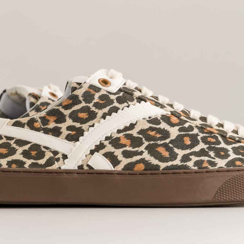 Leopard print barefoot sneaker with brown sole on a gray background