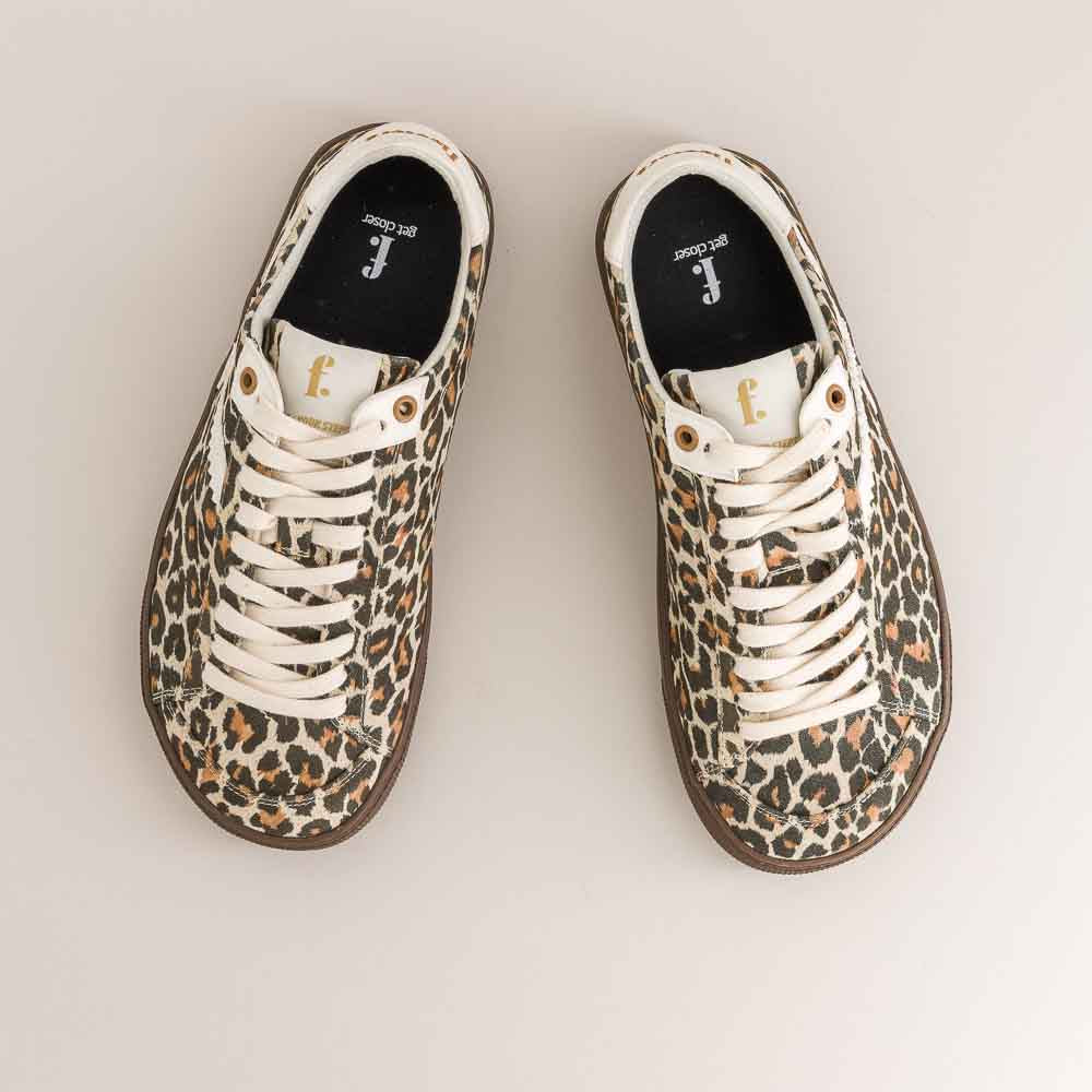 Pair of animal print barefoot sneakers on a light background