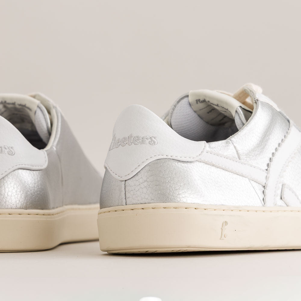 White and silver barefoot sneakers with 'Fleeters' branding on a light background