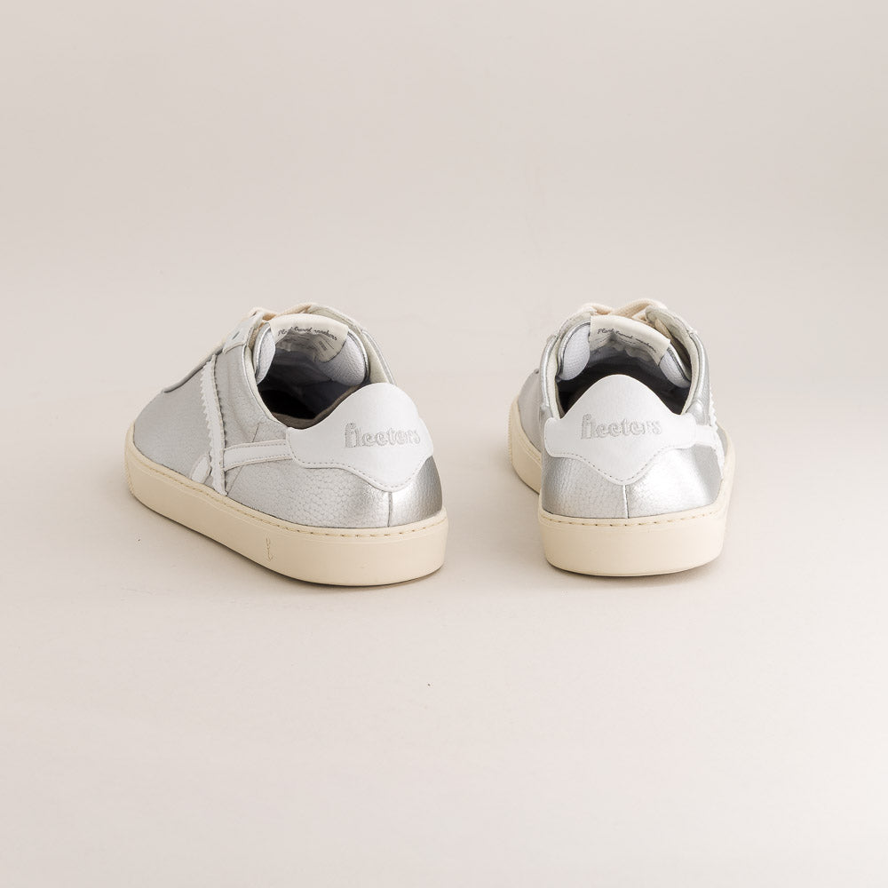 Pair of silver barefoot sneakers on a light gray background