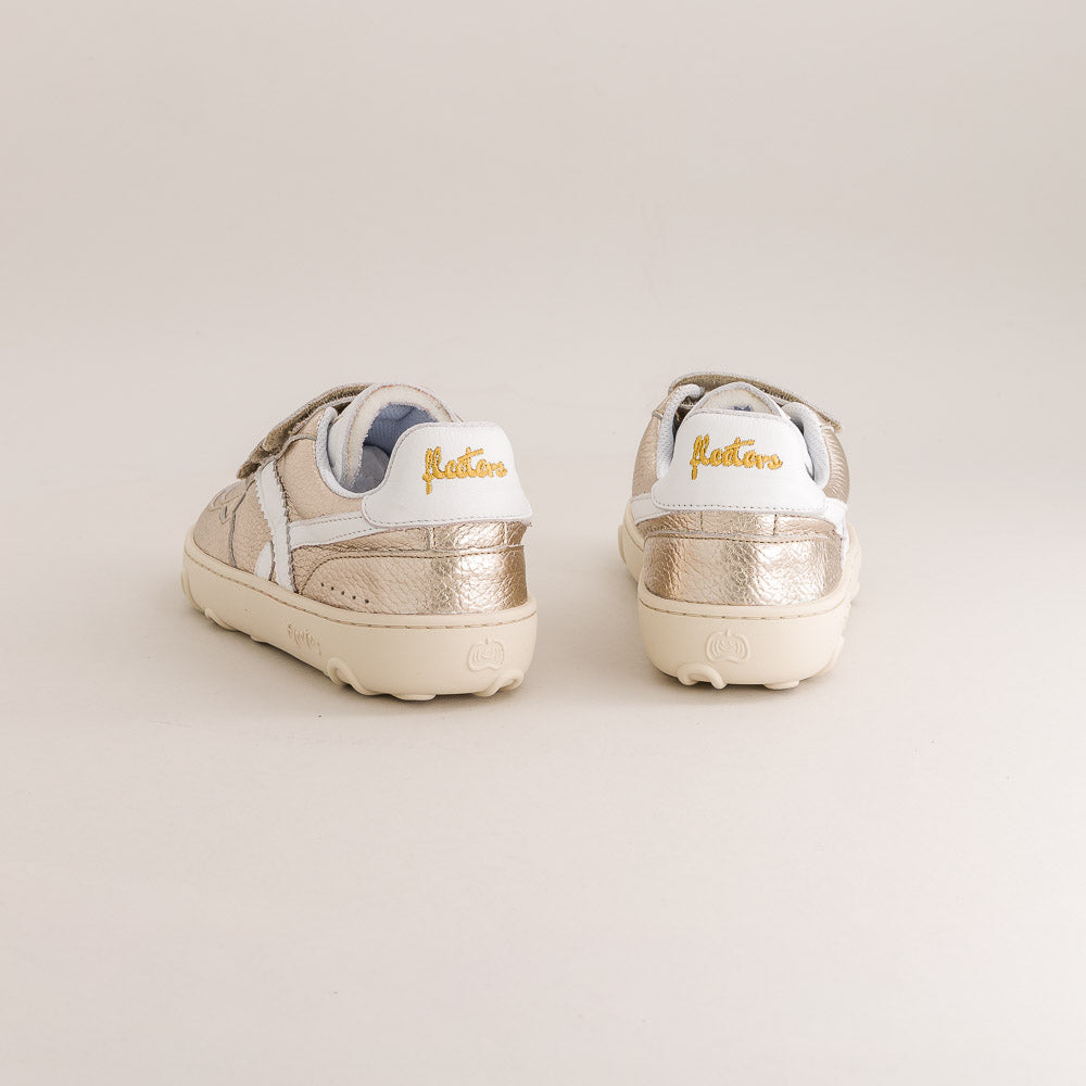 Pair of metallic kids barefoot sneakers with 'Fleeters' branding on a light background