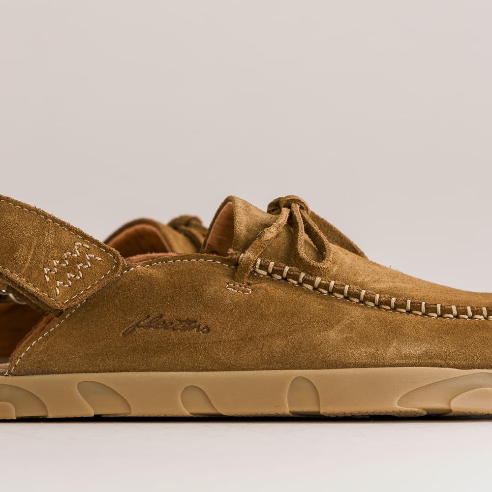 A close-up side view of a tan suede boat shoe sandal with a thick beige sole, featuring a stitched detail and the brand name 'Fiestas' embossed on the side.