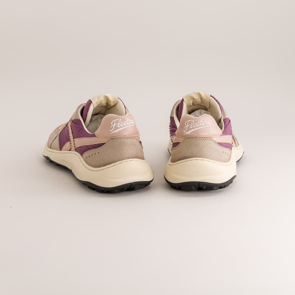 A pair of low-top barefoot sneakers shown from the back, featuring beige suede and leather panels, purple accents, and cream-colored soles. The brand name 'Fleeters' is embroidered on the heel area.