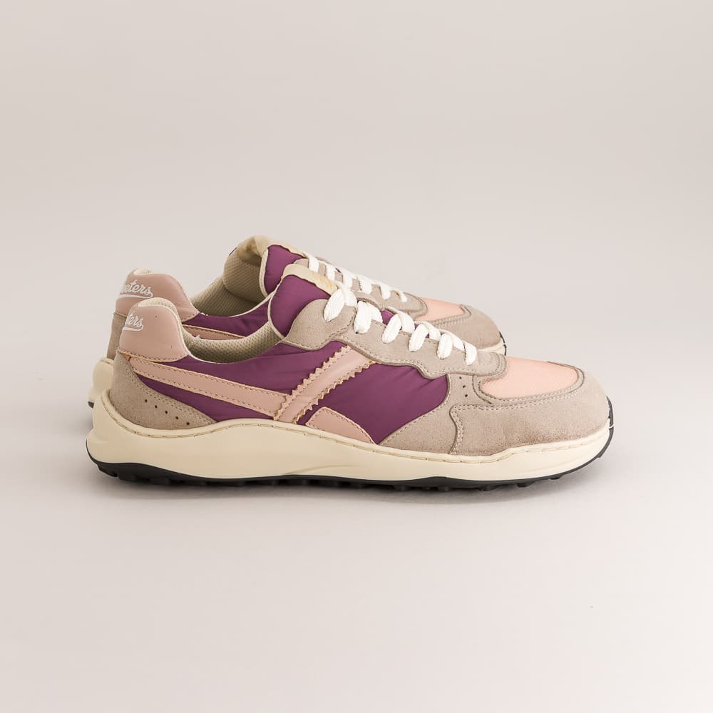 A pair of retro-style platform barefoot  sneakers in beige suede and pink leather with purple suede panels, white laces, and a thick cream midsole, shown against a neutral light gray background.