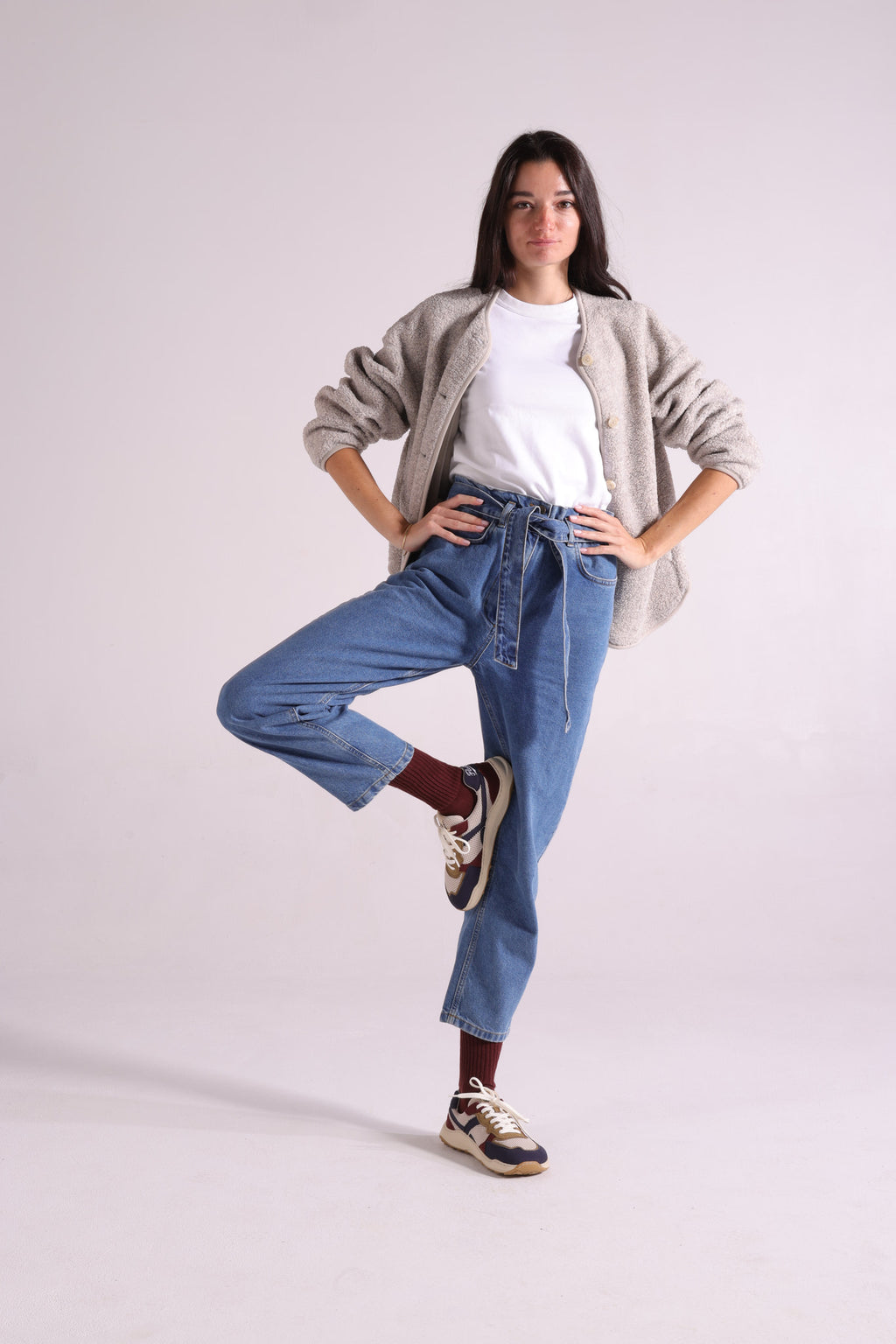 Woman wearing jeans with retro-style barefoot sneakers