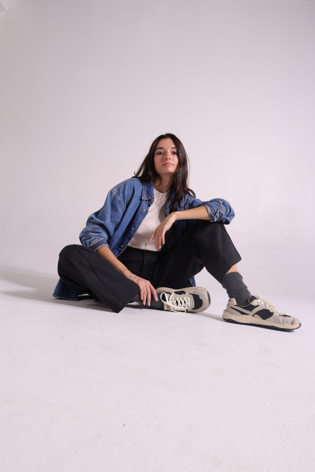 A woman posing with barefoot sneakers