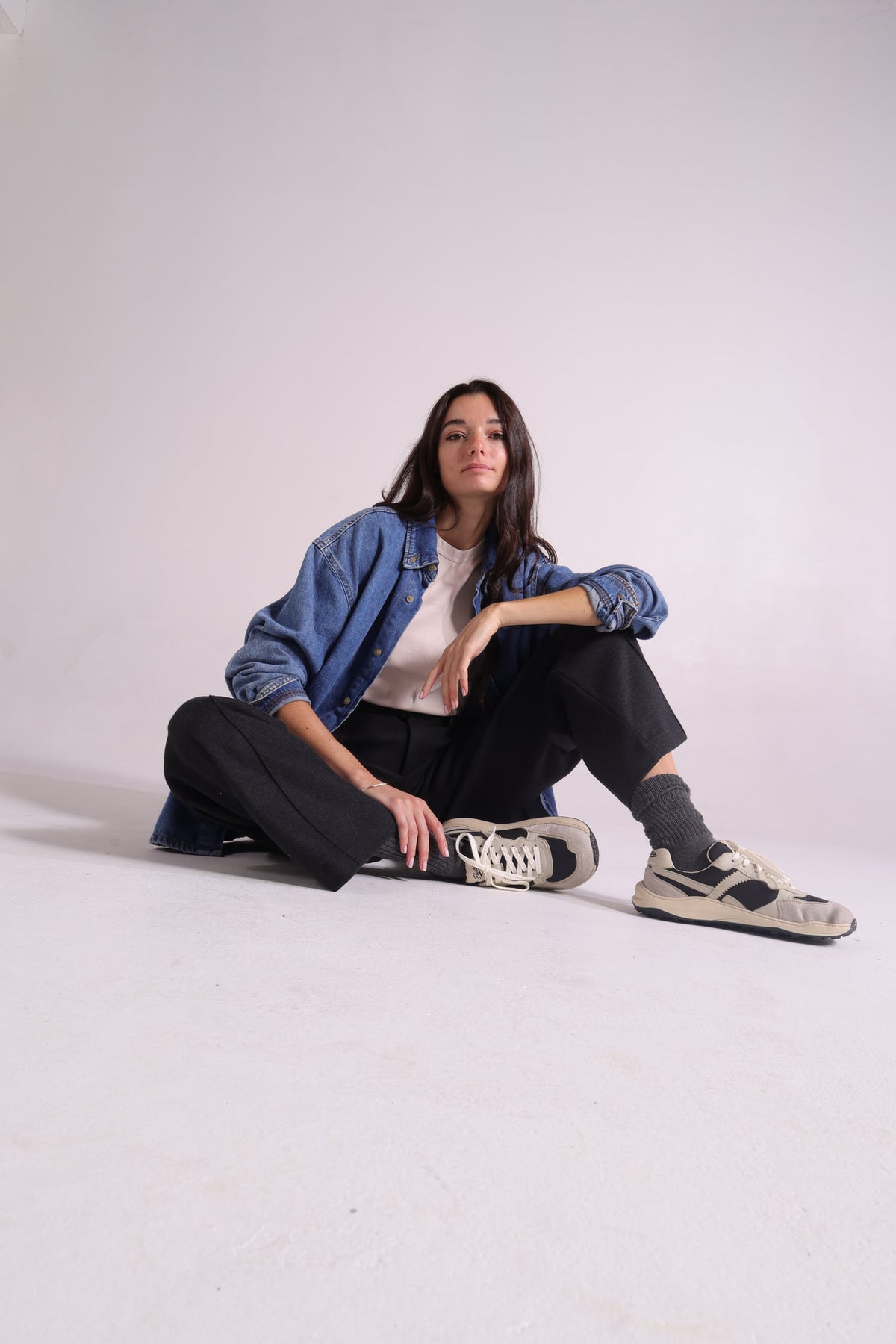 A woman posing with barefoot sneakers