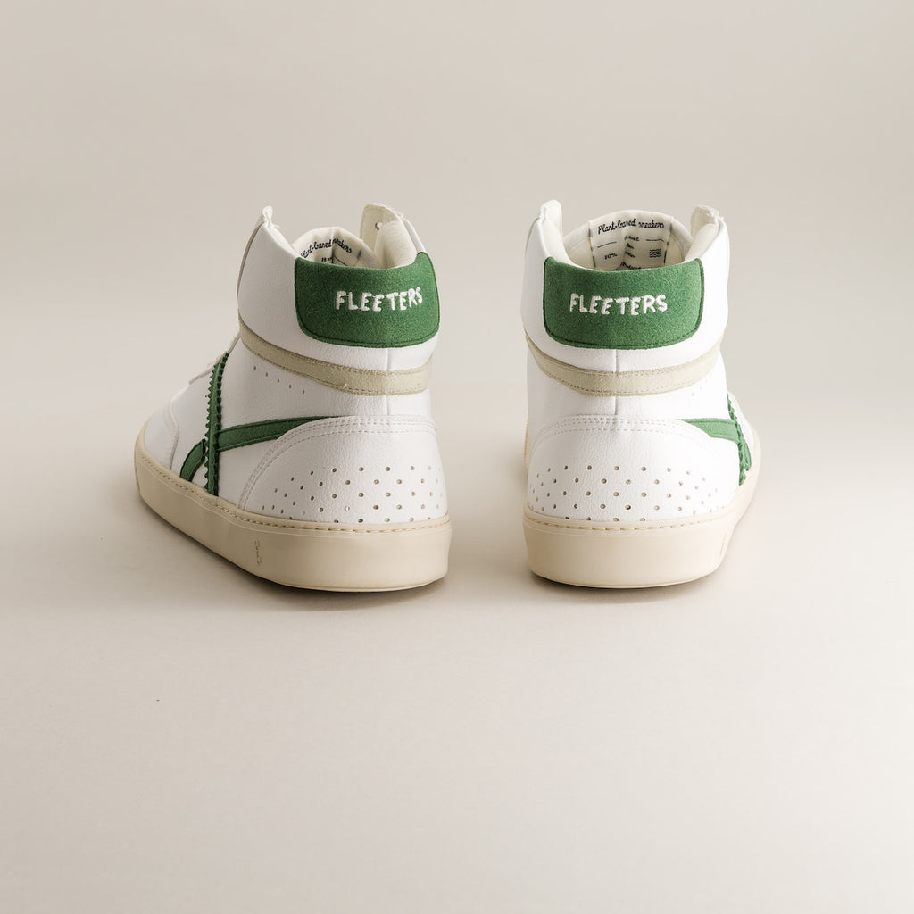 White mid-ankle barefoot sneakers with green accents and 'Fleeters' branding on a light background