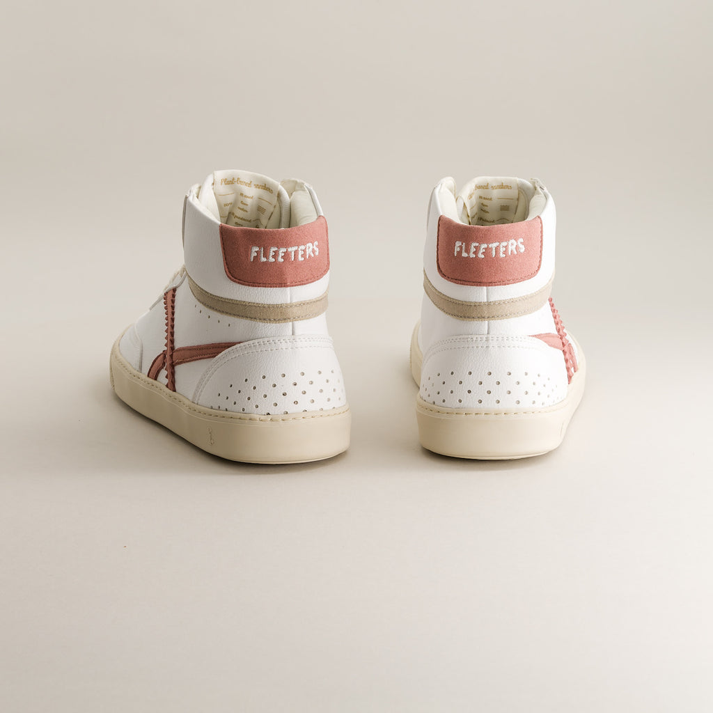 Pair of white mid-ankle barefoot sneakers with red accents on a light gray background