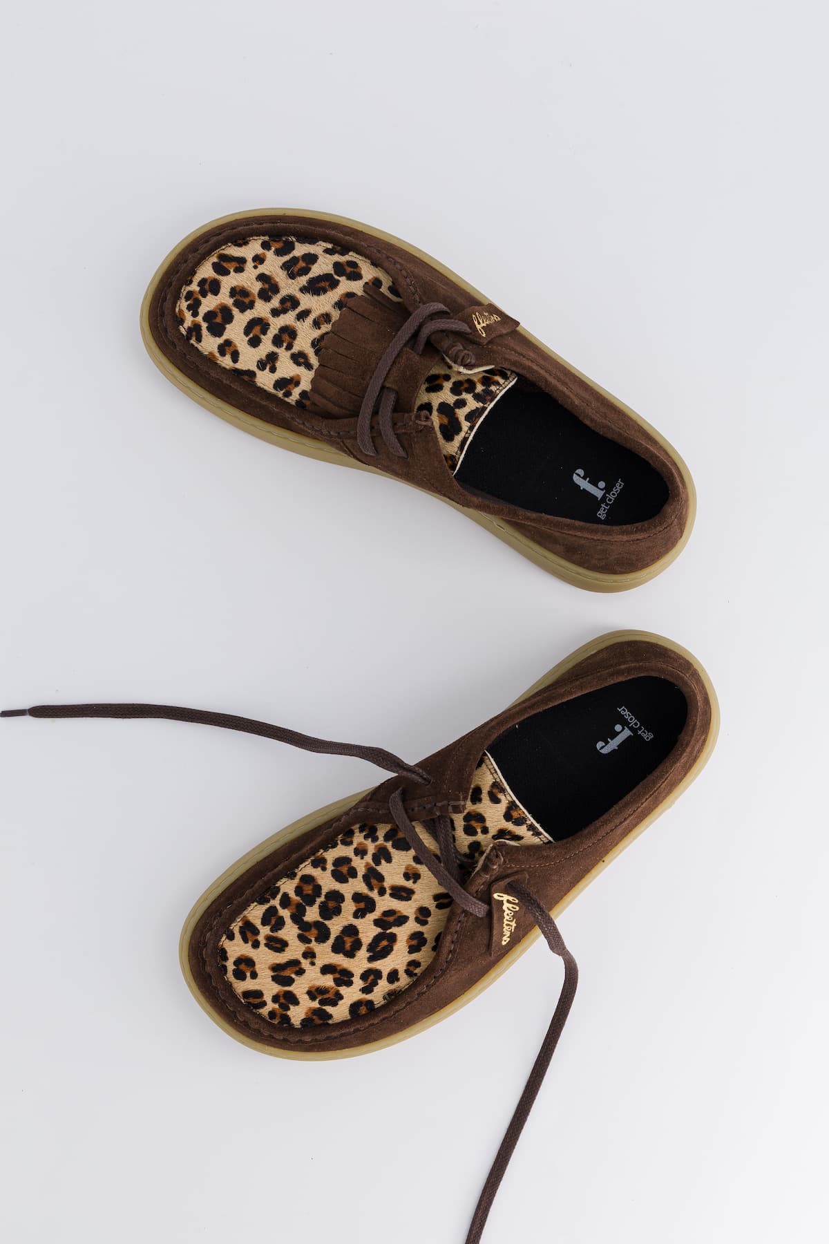 Brown shoes with leopard print pattern on a white background
