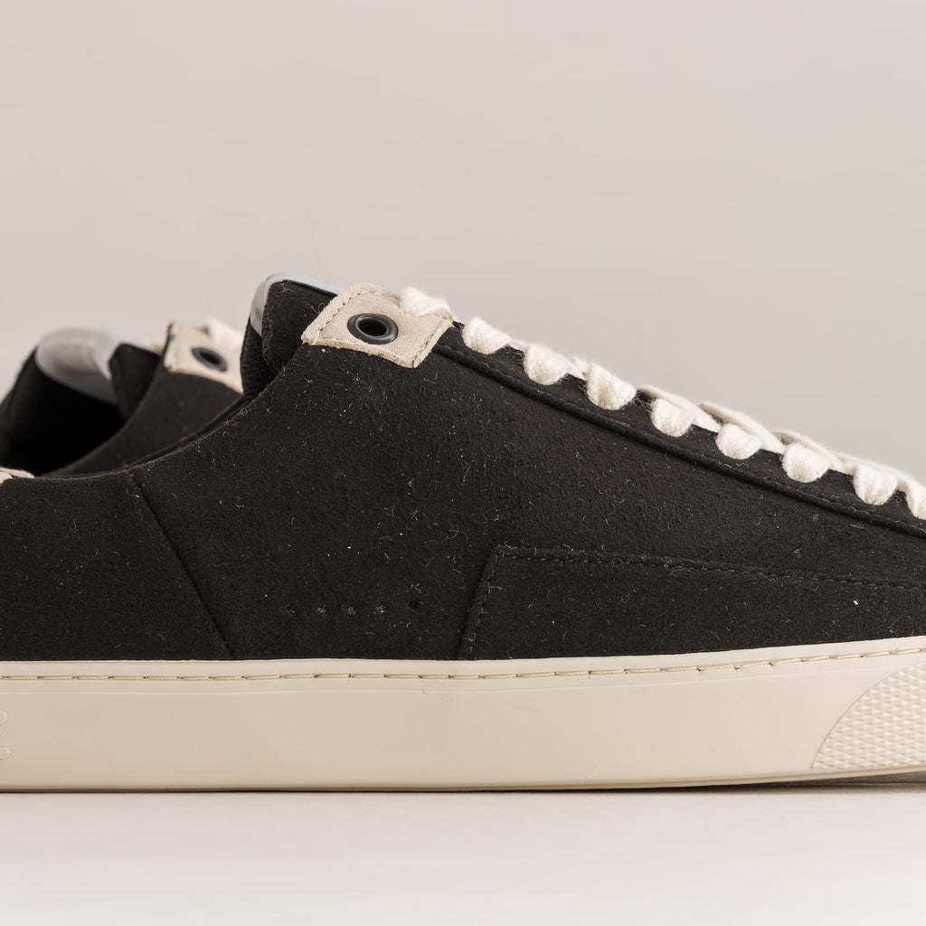 black barefoot sneakers with off-white sole - close-up side view