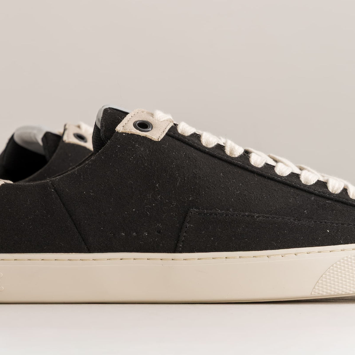 black barefoot sneakers with off-white sole - close-up side view
