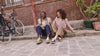 Two people wearing barefoot sneakers in a Parisian alley