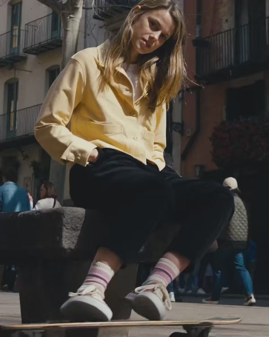 Woman wearing barefoot shoes walking and skating in an urban background